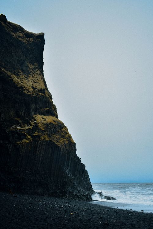 Free Stunning view of Iceland's basalt formations along the ocean's edge with dramatic cliffs. Stock Photo