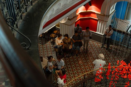 Free Tourists explore a vibrant indoor historic site in Sydney, Australia. Stock Photo