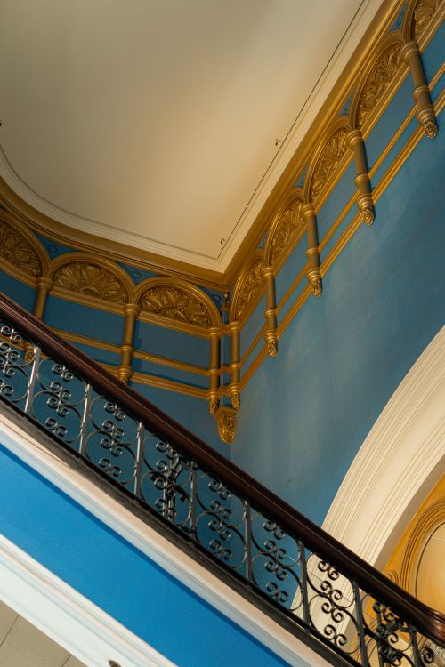 Free Ornate staircase with gold accents and blue walls in Sydney's historic architecture. Stock Photo