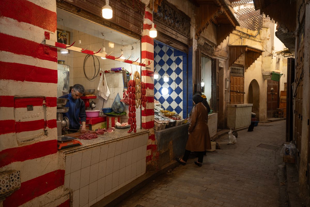 A narrow lantern-lit alley of shops and stalls in the historic Khan el-Khalili bazaar, Cairo