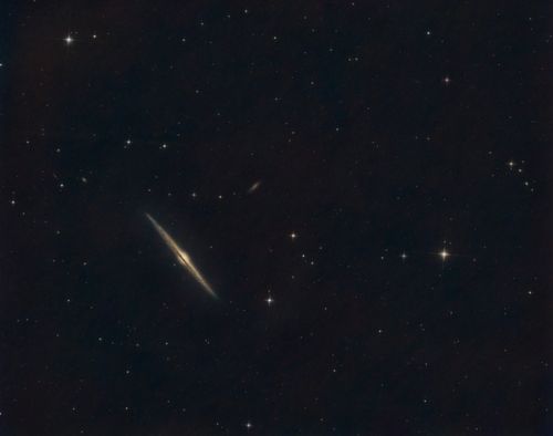 Free Captivating view of a star-filled night sky featuring an edge-on galaxy and scattered bright stars. Stock Photo