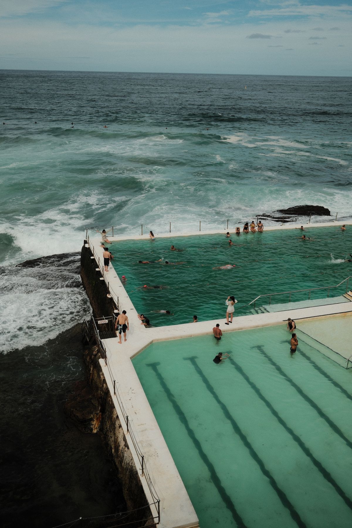 Bondi Icebergs swimming pool with ocean waves and swimmers in Sydney, Australia. Stock Photo.