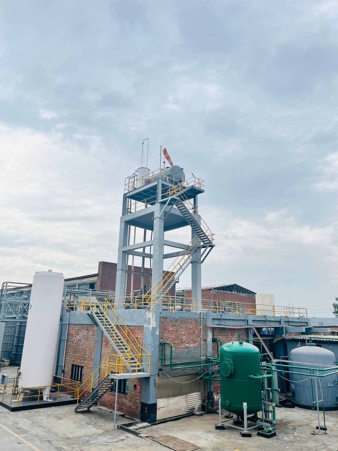 Industrial Facility with Machinery under Cloudy Sky · Free Stock Photo