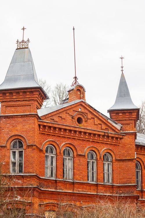 Free Historic red brick building exhibiting Gothic Revival architecture with pointed towers and decorative elements. Stock Photo