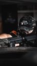 Person Wearing Camouflage Cap Holding Rifle