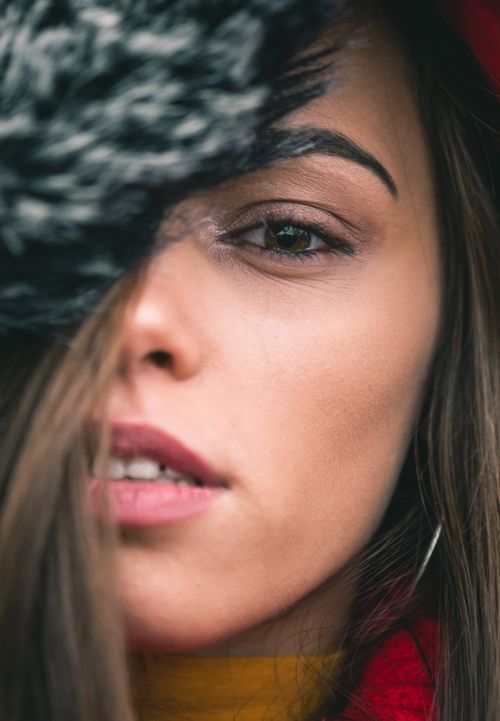 Free Detailed close-up of a woman wearing a hat, showcasing her natural beauty in a stylish portrait. Stock Photo