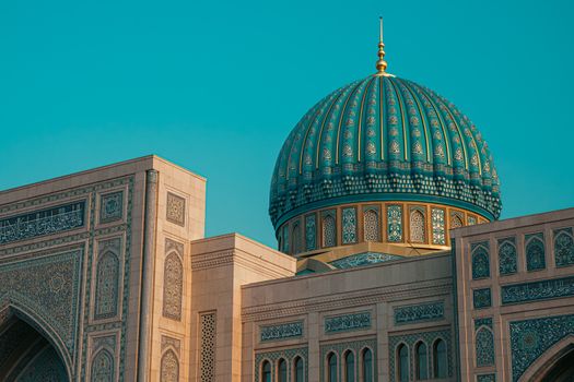 Stunning close-up of the intricate blue dome and architecture of a historic building in Uzbekistan.