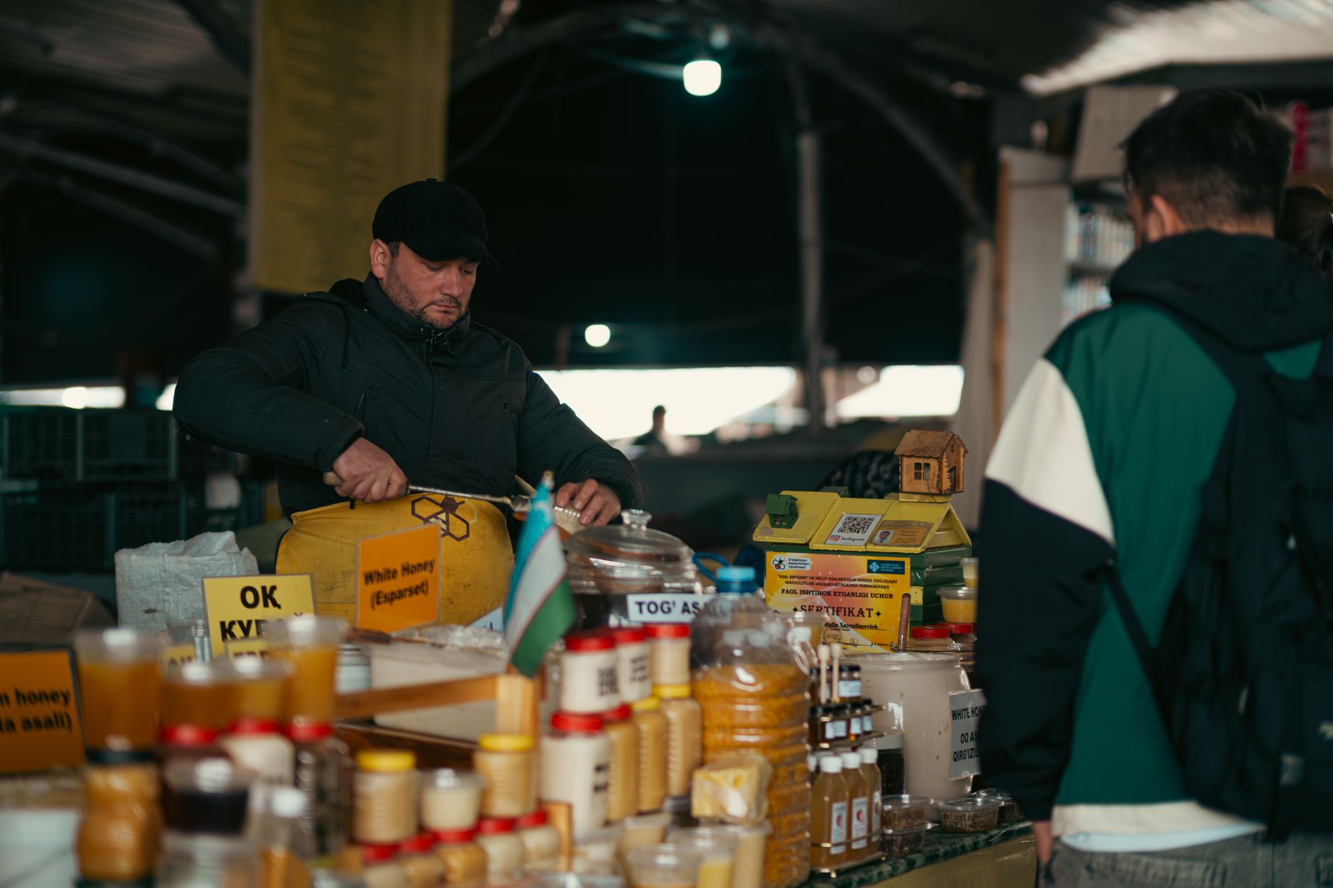 Stall of jarred lyutenitsa and honey at Zhenski Pazar market