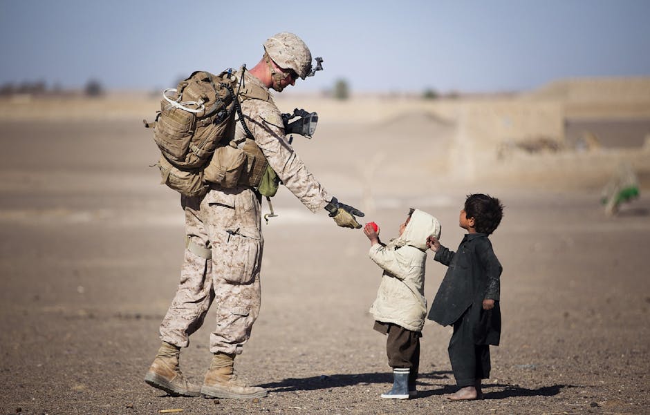 Soldier Giving Red Fruit on 2 Children during Daytime