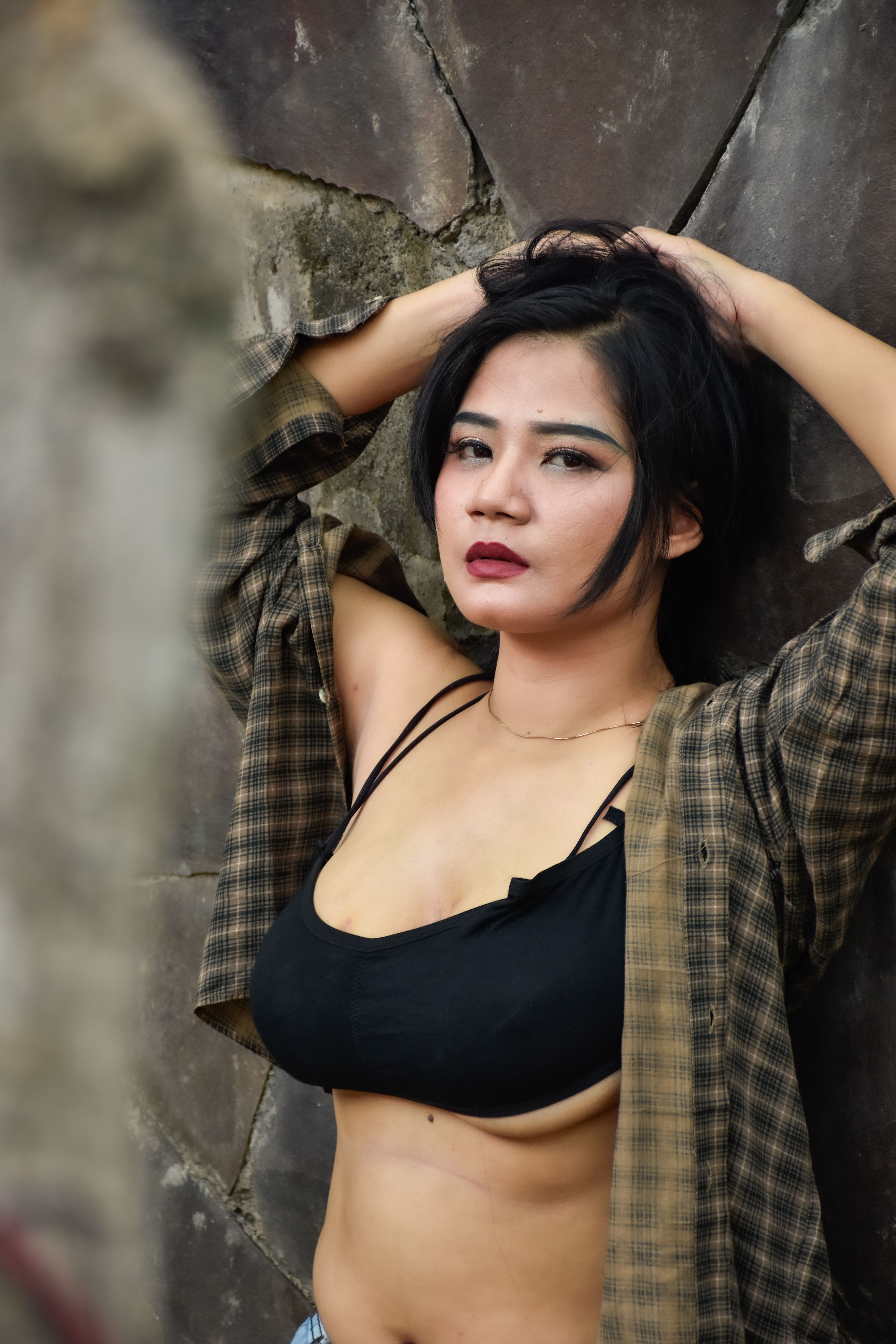 Stylish Young Woman Posing Against Stone Wall