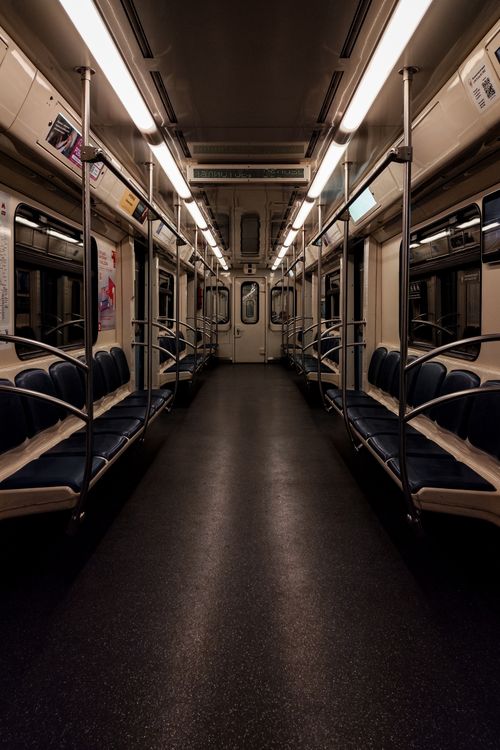 Free Moody interior view of an empty subway car at night, showcasing blue seating arrangement. Stock Photo