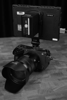 Professional camera rig featuring a lens and external monitor in a sophisticated setup.