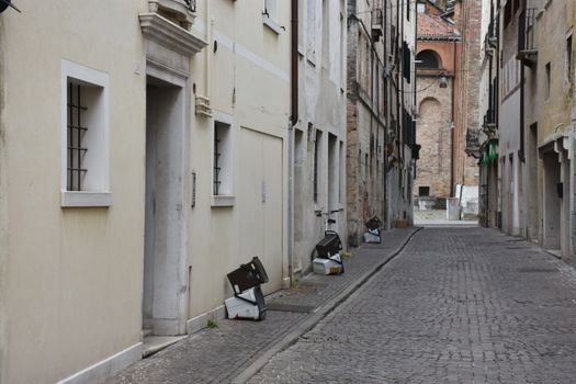 Charming cobblestone alleyway in the historic city of Treviso, Italy, showcasing classic architecture.
