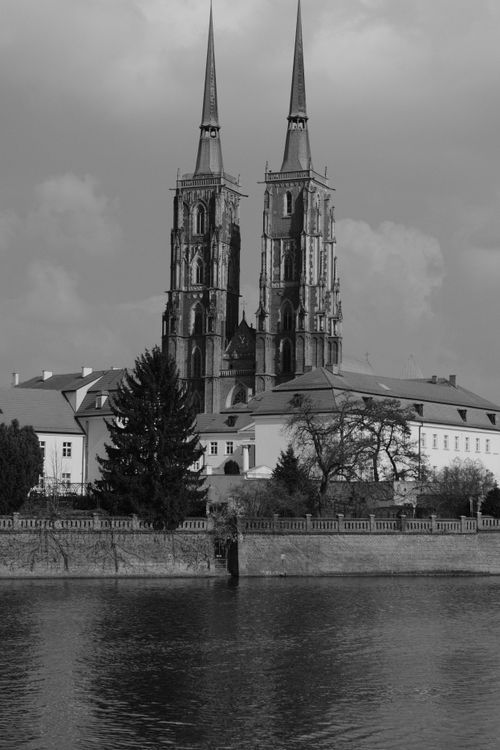 Free Black and white photo of Wroclaw Cathedral reflecting Gothic style by the river. Stock Photo
