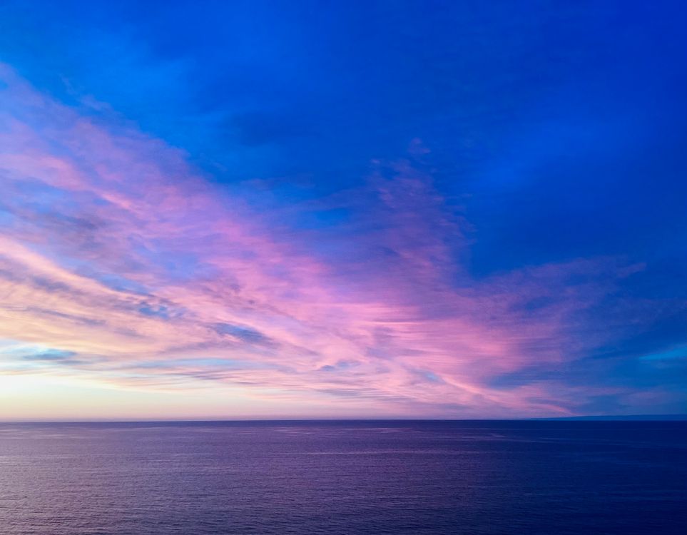 Stunning Sunset Over Ocean with Colorful Clouds · Free Stock Photo