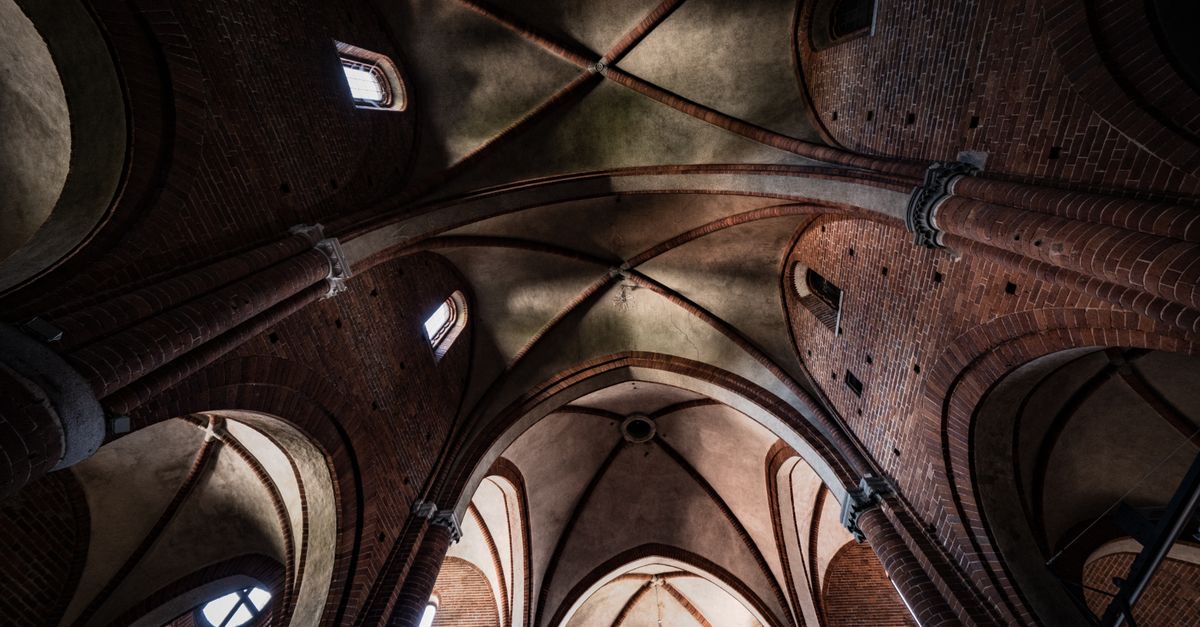A striking view of gothic arches and brickwork inside a historic cathedral, showcasing architectural elegance.