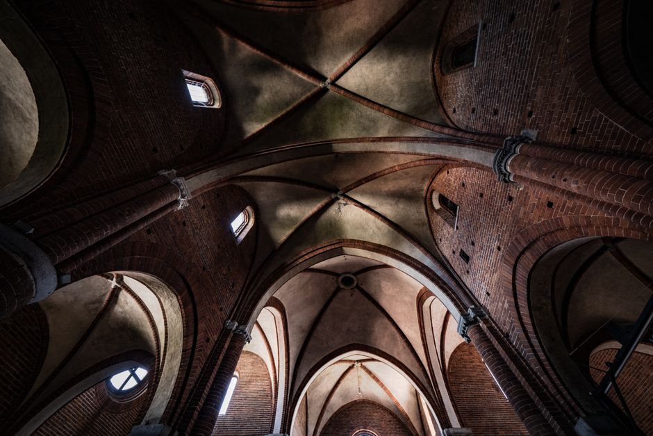 A striking view of gothic arches and brickwork inside a historic cathedral, showcasing architectural elegance.