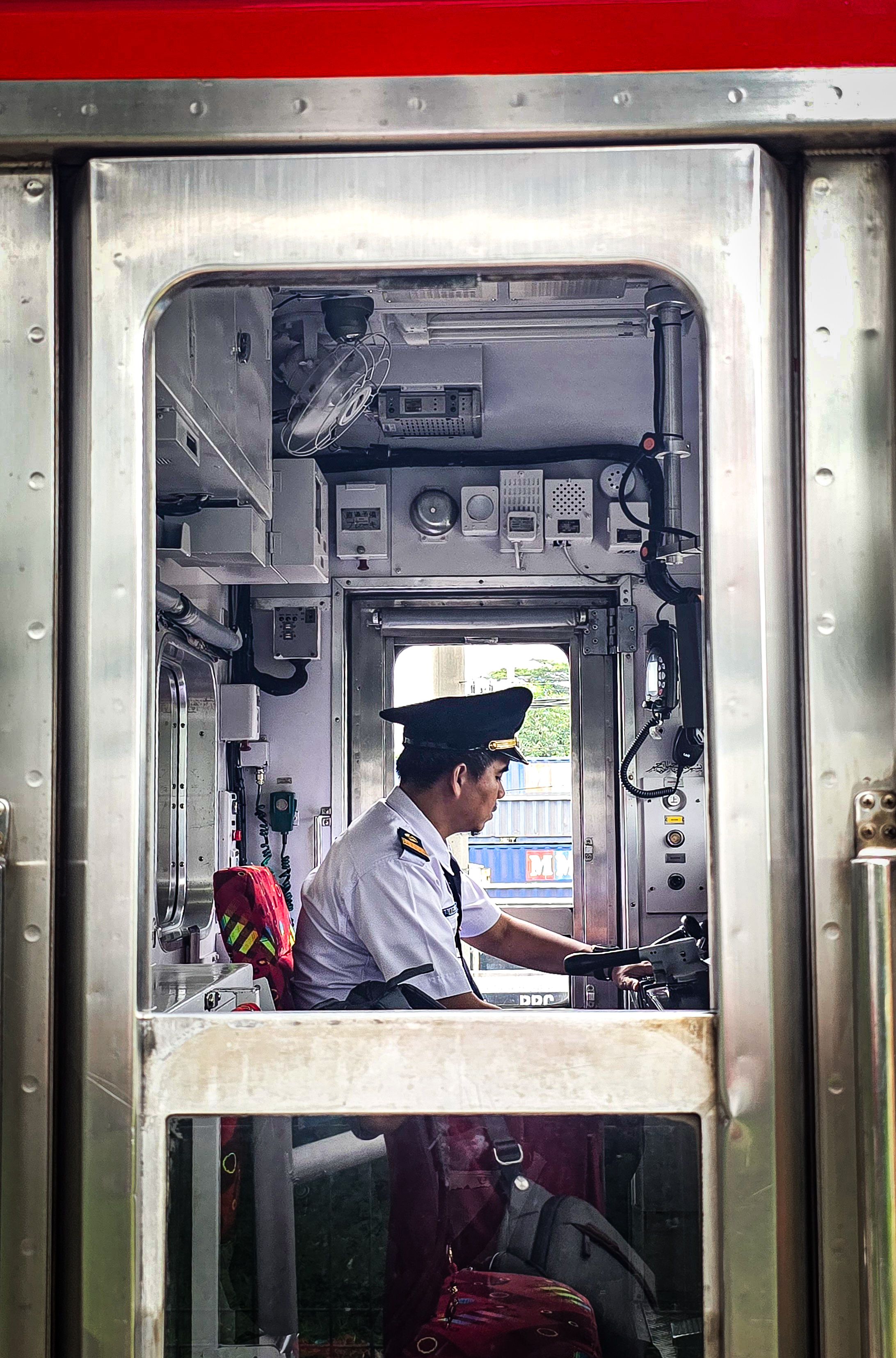 Train Conductor Operating the Driver's Cabin · Free Stock Photo