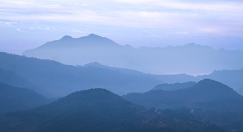 Free Tranquil layers of misty mountains at dawn showcasing natural beauty. Stock Photo