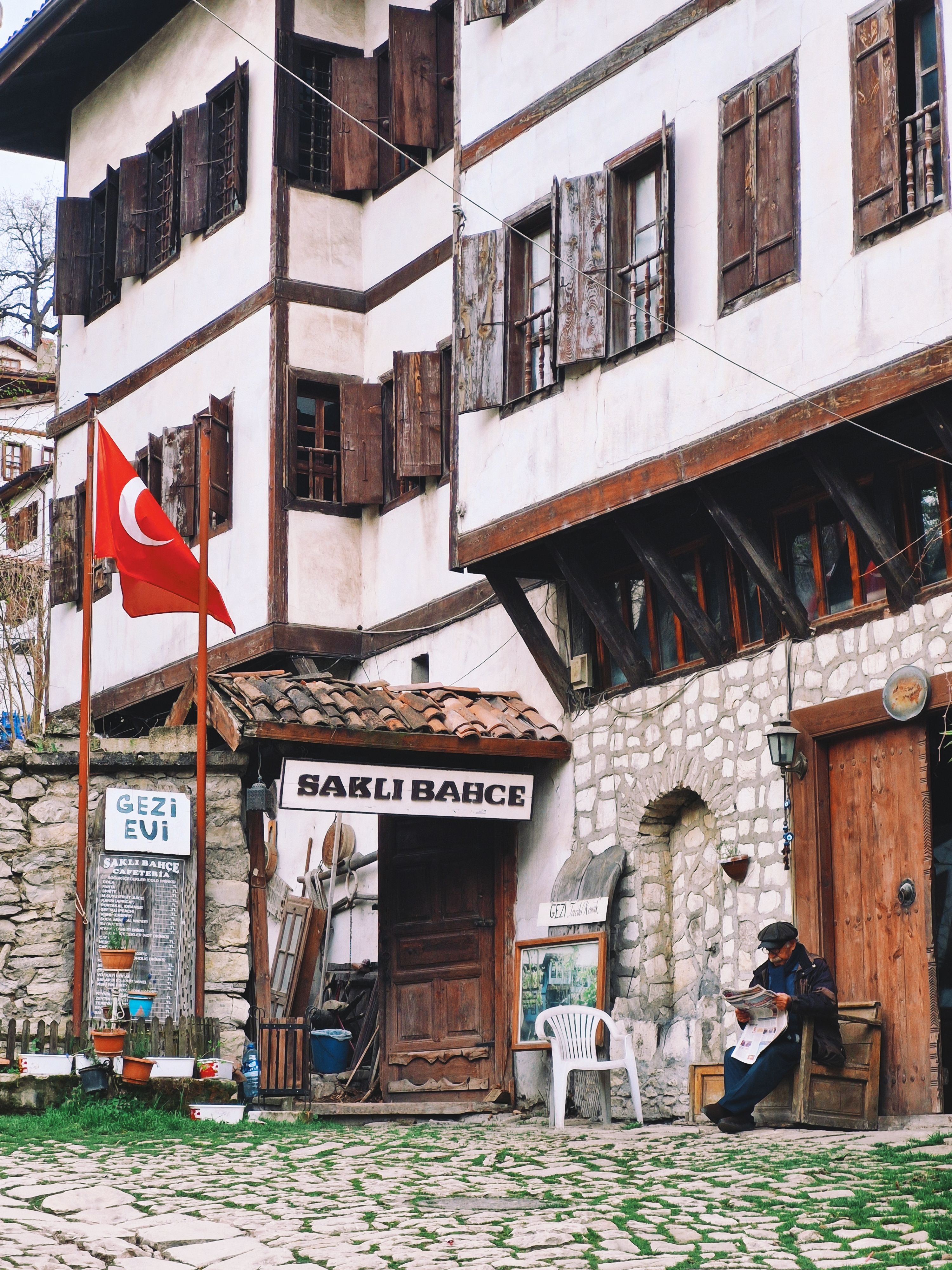 Charming scene of traditional Turkish buildings with a flag in Safranbolu.