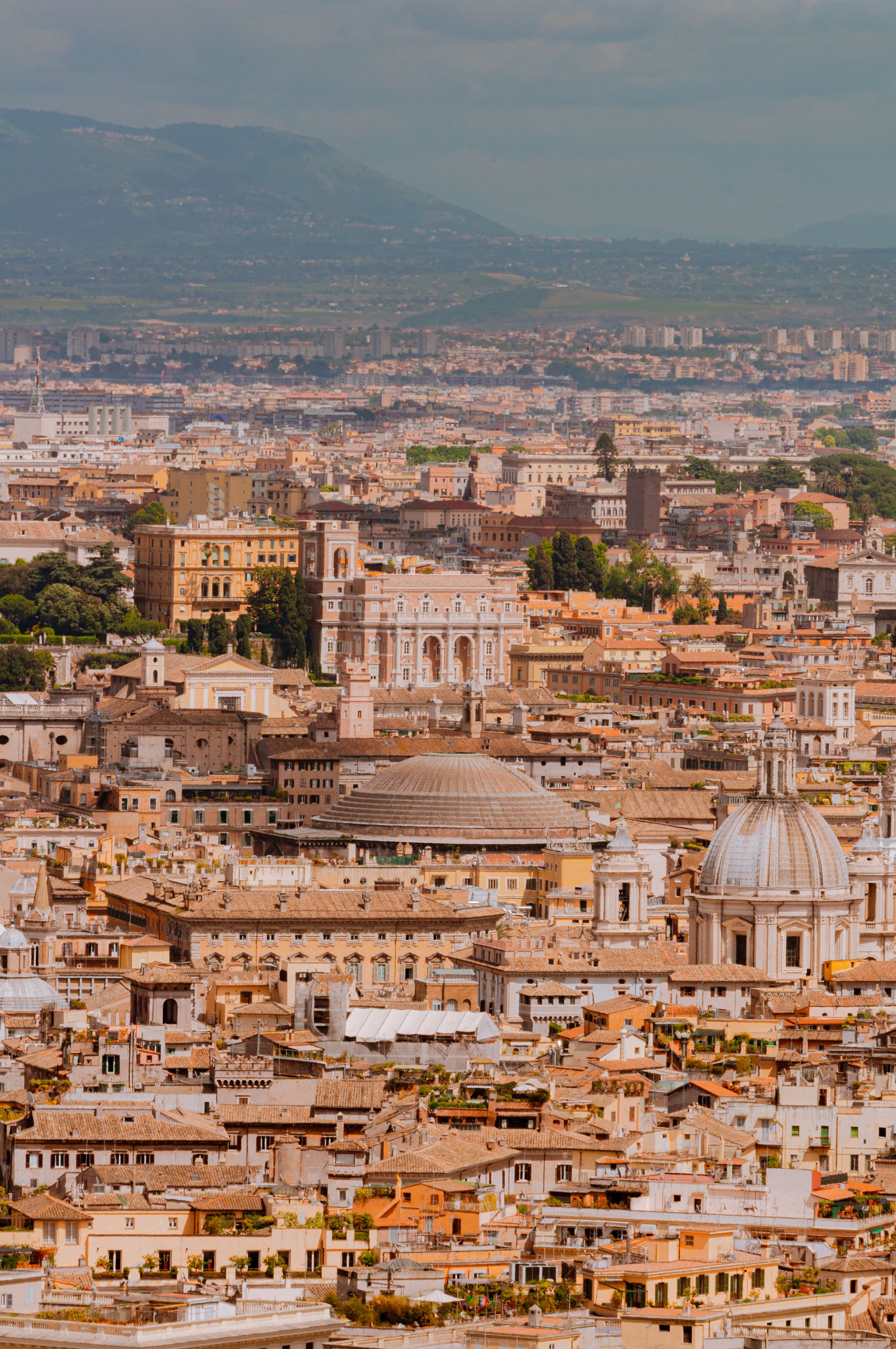 Stunning aerial shot of Rome showcasing its rich historical architecture under a warm light.