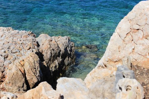 Free Explore the rugged beauty of a rocky coastline with clear blue waters in Greece. Stock Photo