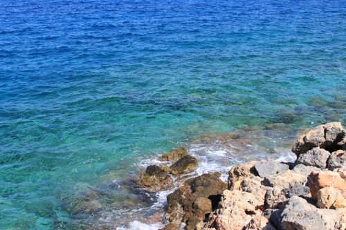 Free Stunning view of clear Mediterranean waters and rocky coastline in Greece, perfect for travel inspiration. Stock Photo