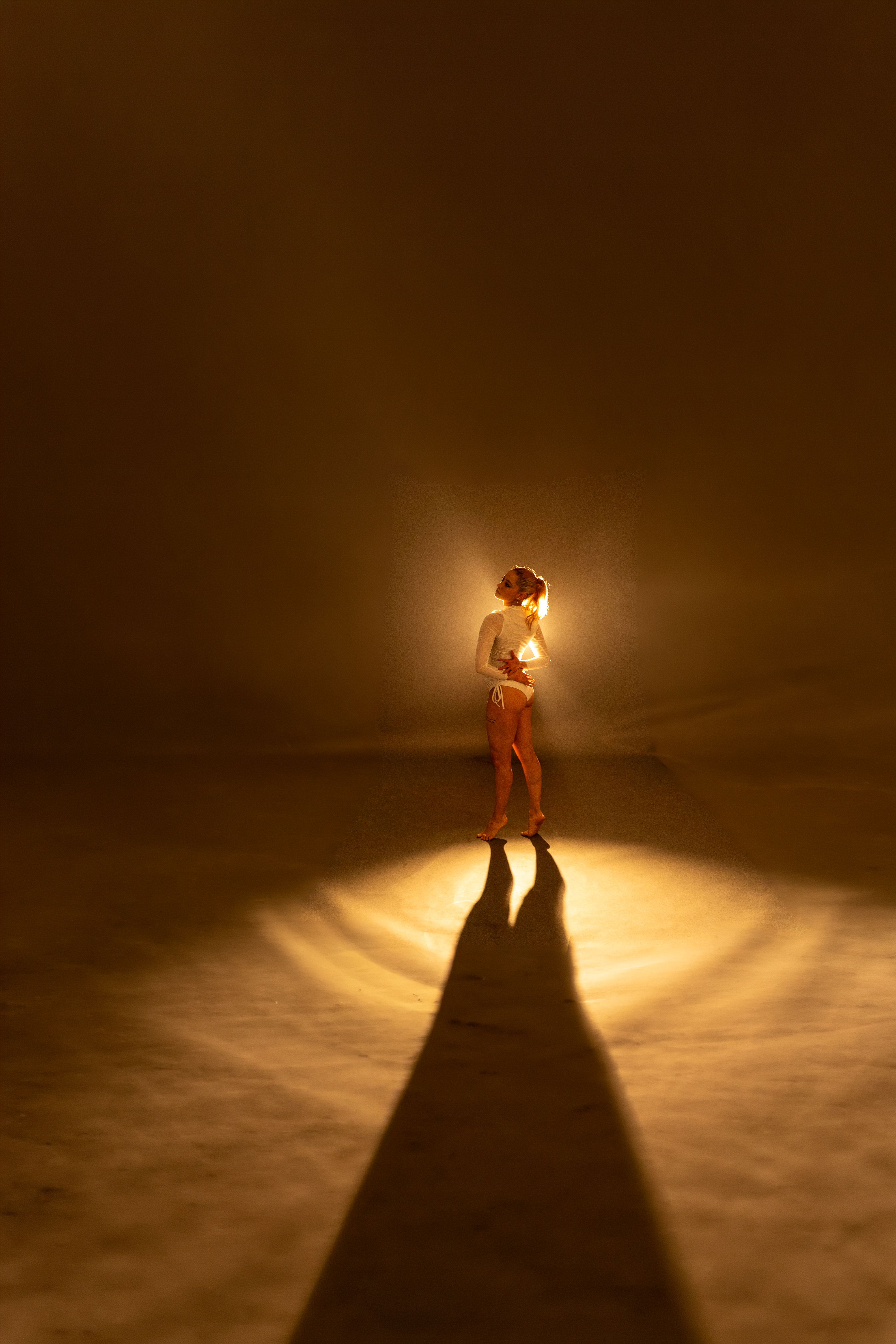 Elegant Dancer Backlit in Dramatic Studio Setting · Free Stock Photo