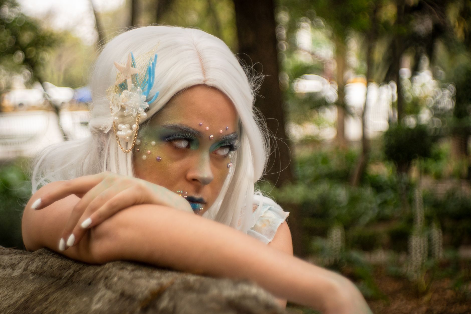A creative portrait of a woman in fantasy cosplay makeup with a nature backdrop in Mexico City.