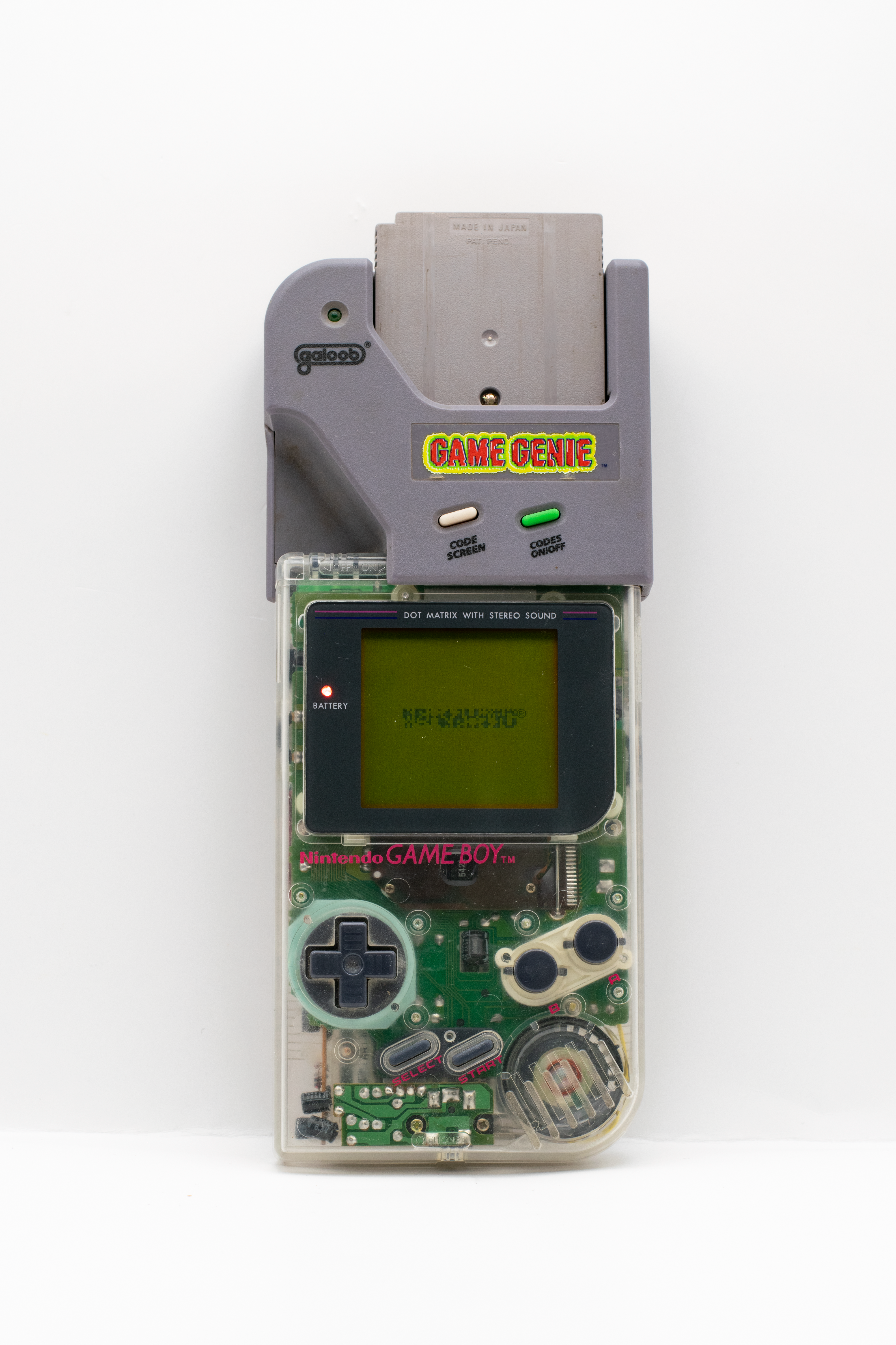 Classic Nintendo Game Boy with Game Genie attachment showcasing retro gaming nostalgia.