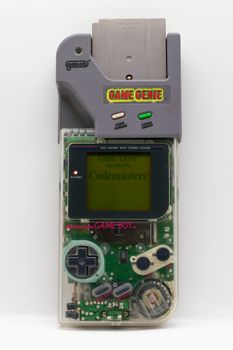 Vintage Nintendo Game Boy with a Game Genie enhance retro gaming experience.