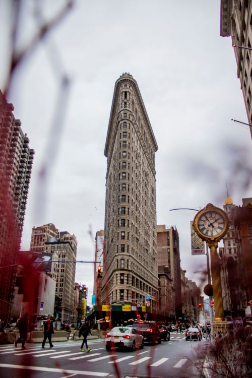 Free Iconic Flatiron Building in Manhattan, New York City, with bustling street and urban architecture. Stock Photo