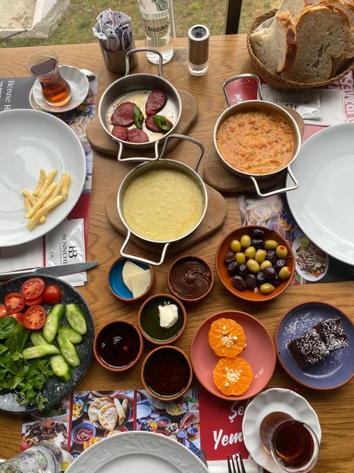 Free A vibrant traditional Turkish breakfast spread with various dishes and drinks on a wooden table. Stock Photo