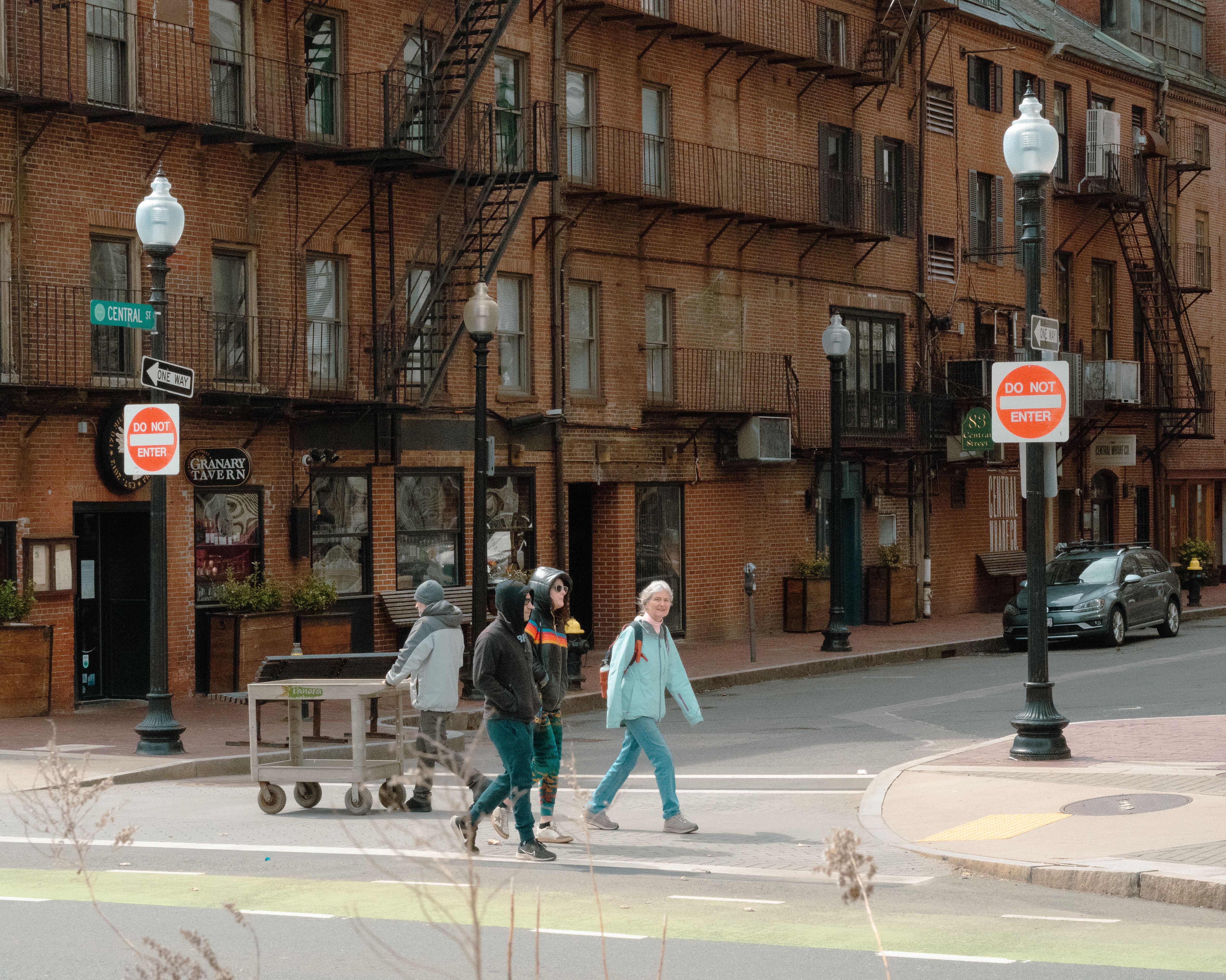 community mediation center sign on brick building with people entering