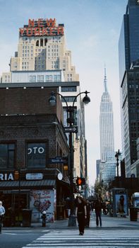 Dynamic street view of New York City featuring the New Yorker and Empire State Buildings.