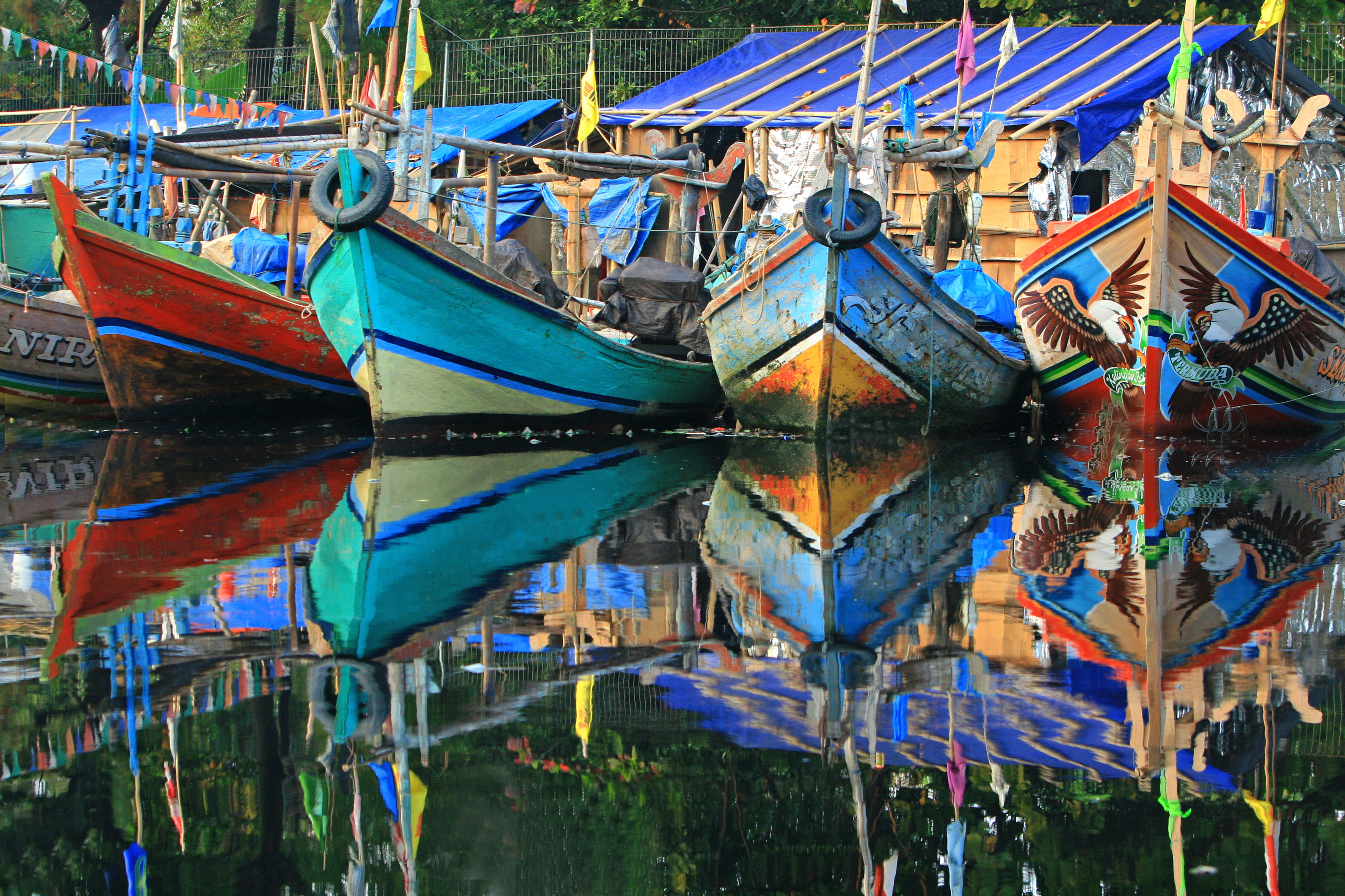 Colorful Wooden Boats Reflecting on Water · Free Stock Photo