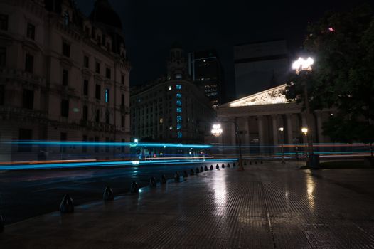 Captivating long exposure of bustling Buenos Aires streets at night, showcasing historic architecture.