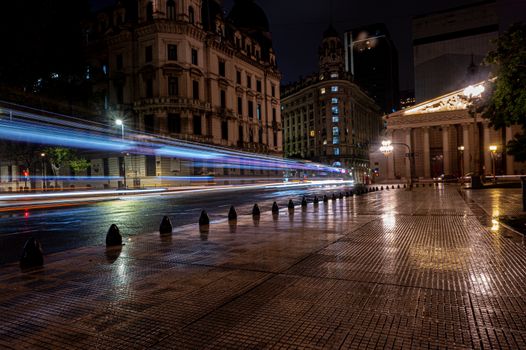 Stunning nighttime cityscape in Buenos Aires with light trails and historic architecture.