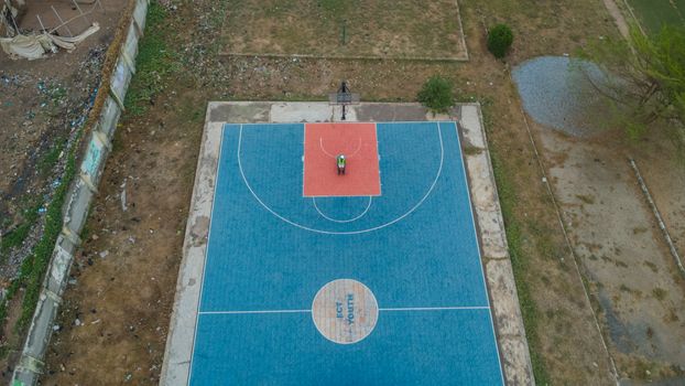 Top-down view of a vibrant basketball court in Abuja, Nigeria.