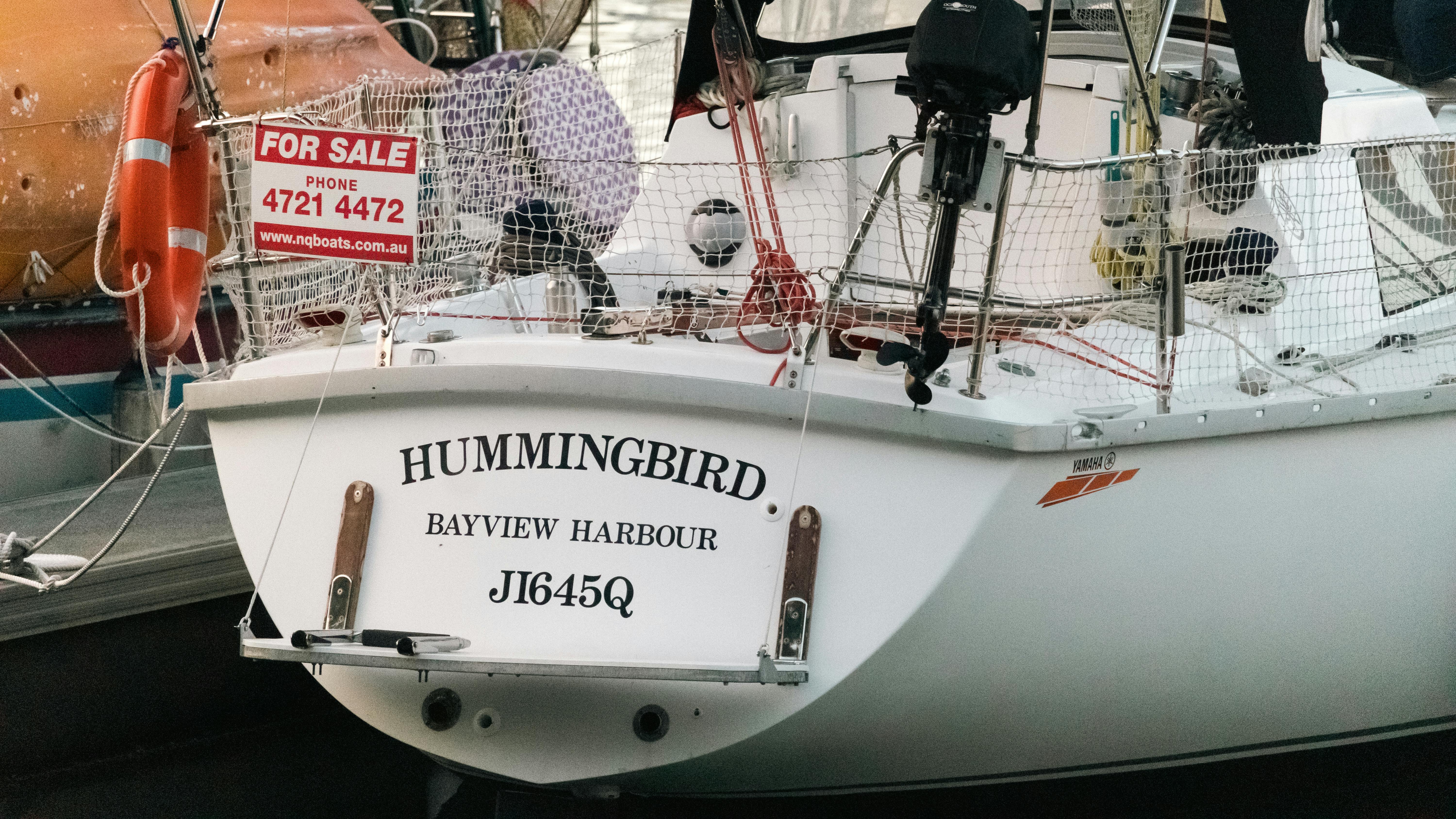Close-up of the 'Hummingbird' sailboat with a for sale sign at Bayview Harbour, Townsville, Australia.