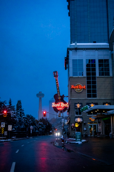 Nighttime view of Hard Rock Cafe and Skylon Tower in snowy Niagara Falls, Ontario.
