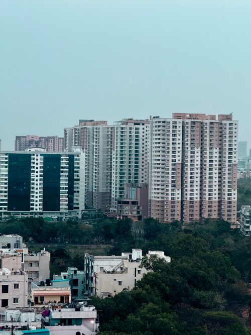 Free A scenic view of modern residential buildings in Hyderabad, India with lush greenery. Stock Photo