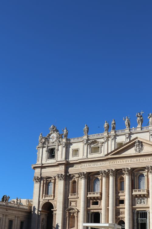 Free Beautiful view of St. Peter's Basilica's facade in Vatican City under a clear blue sky. Stock Photo