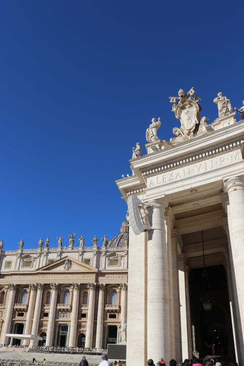 Free A striking view of St. Peter's Basilica showcasing its classic architecture under a clear blue sky. Stock Photo
