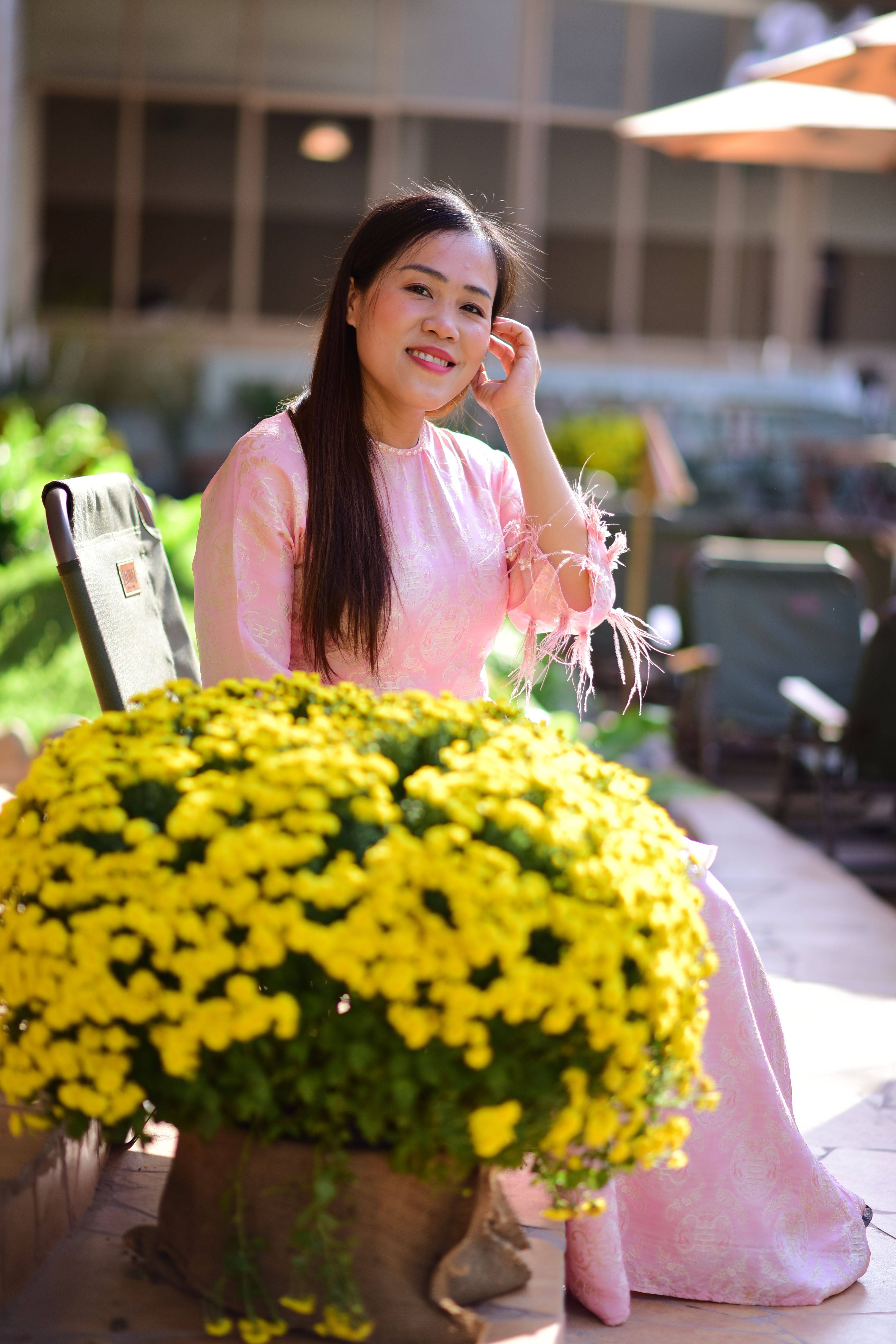 Woman in Pink Dress Sitting by Yellow Flowers Outdoors · Free Stock Photo