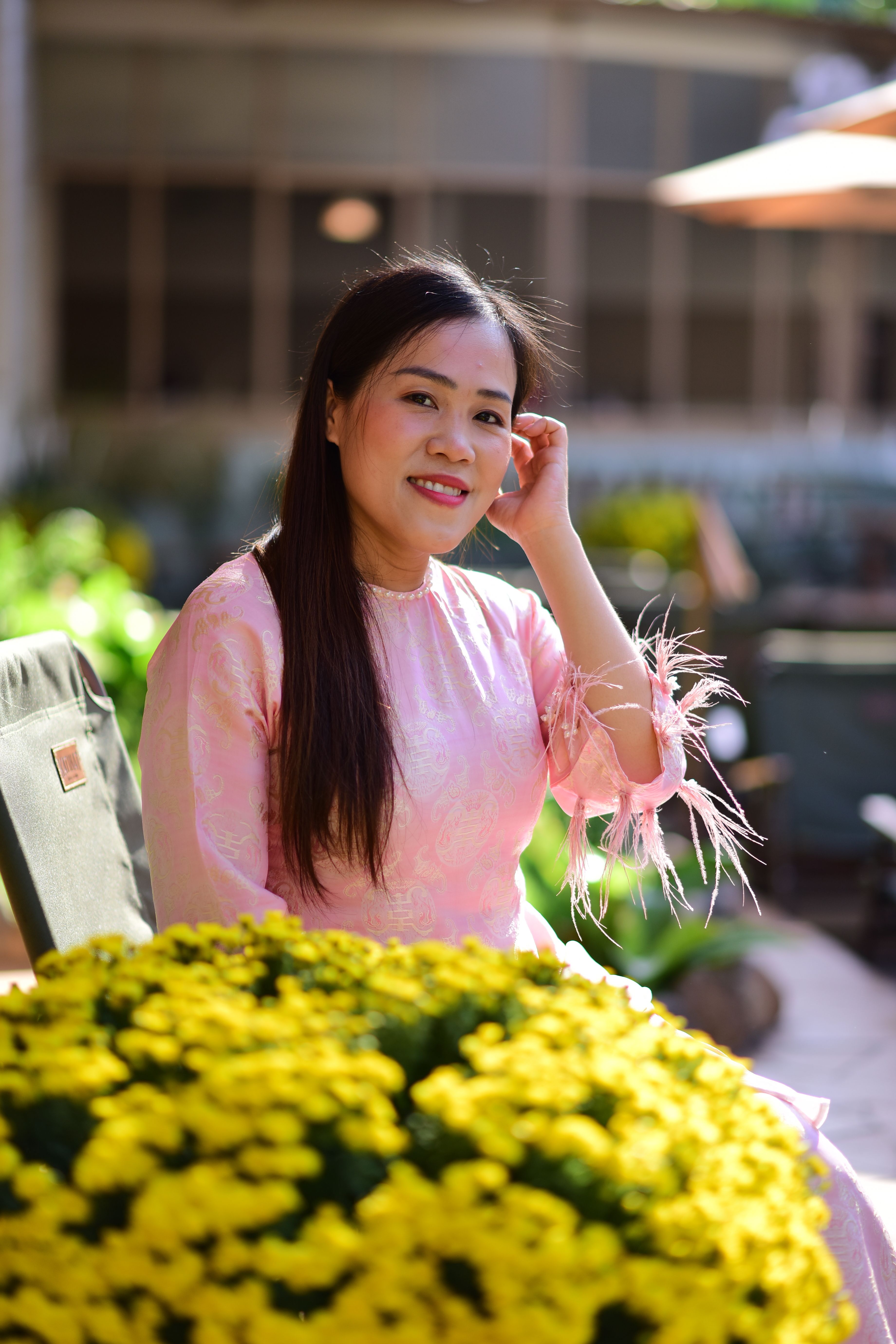 Elegant Woman in Pink Dress with Yellow Flowers · Free Stock Photo
