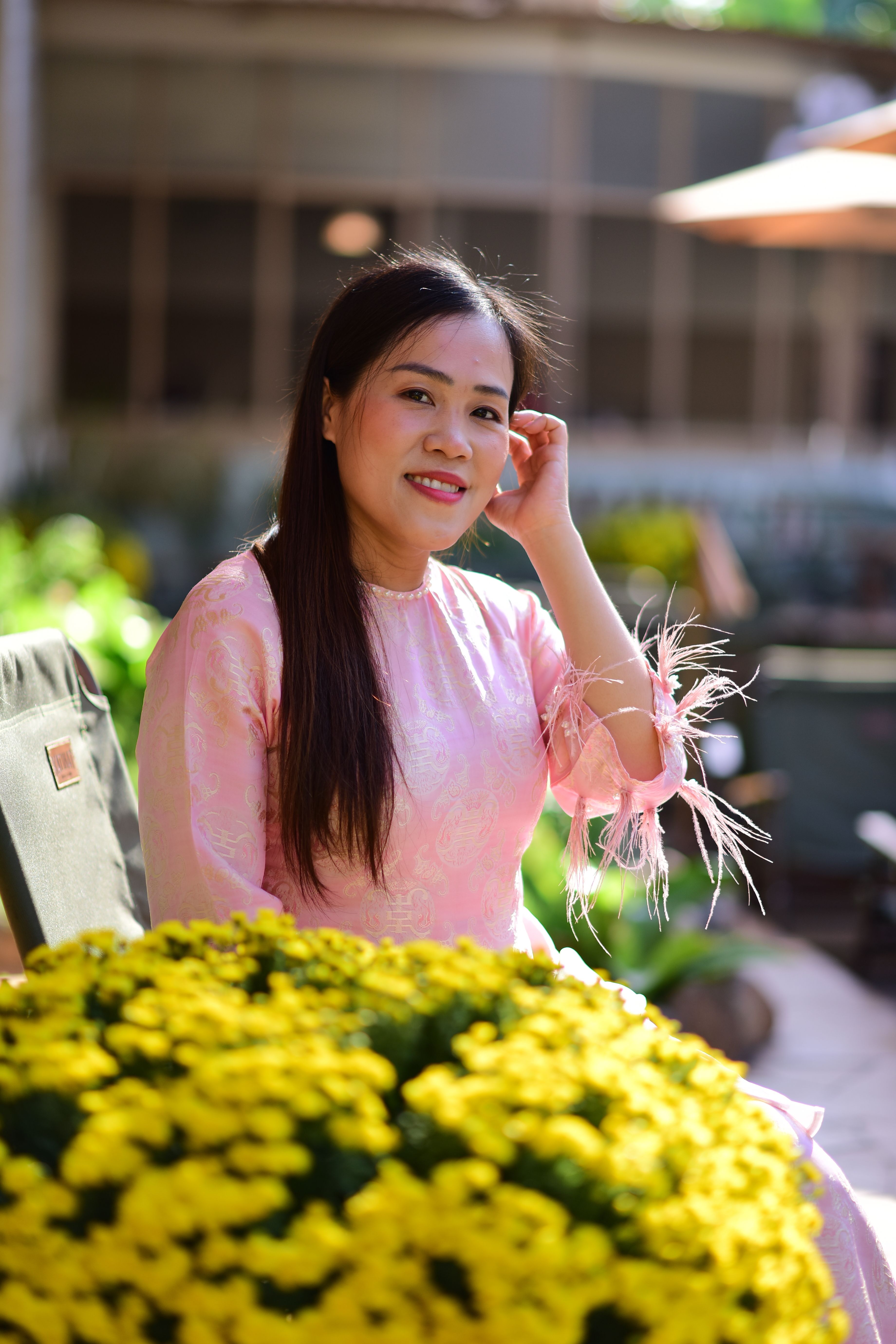 Woman in Pink Dress with Yellow Flowers Outdoors · Free Stock Photo