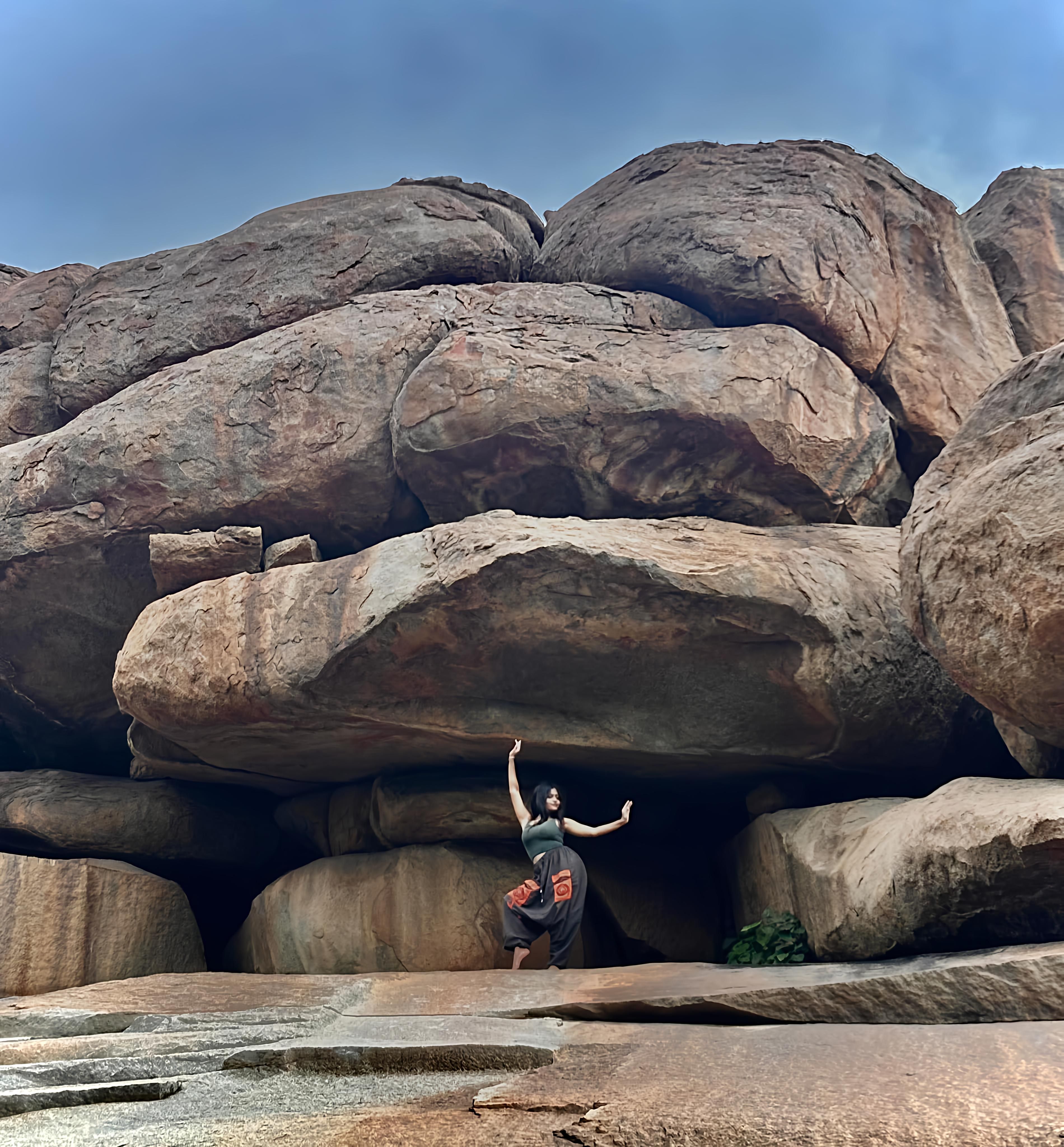 Woman Climbing Large Rocks in Natural Setting · Free Stock Photo