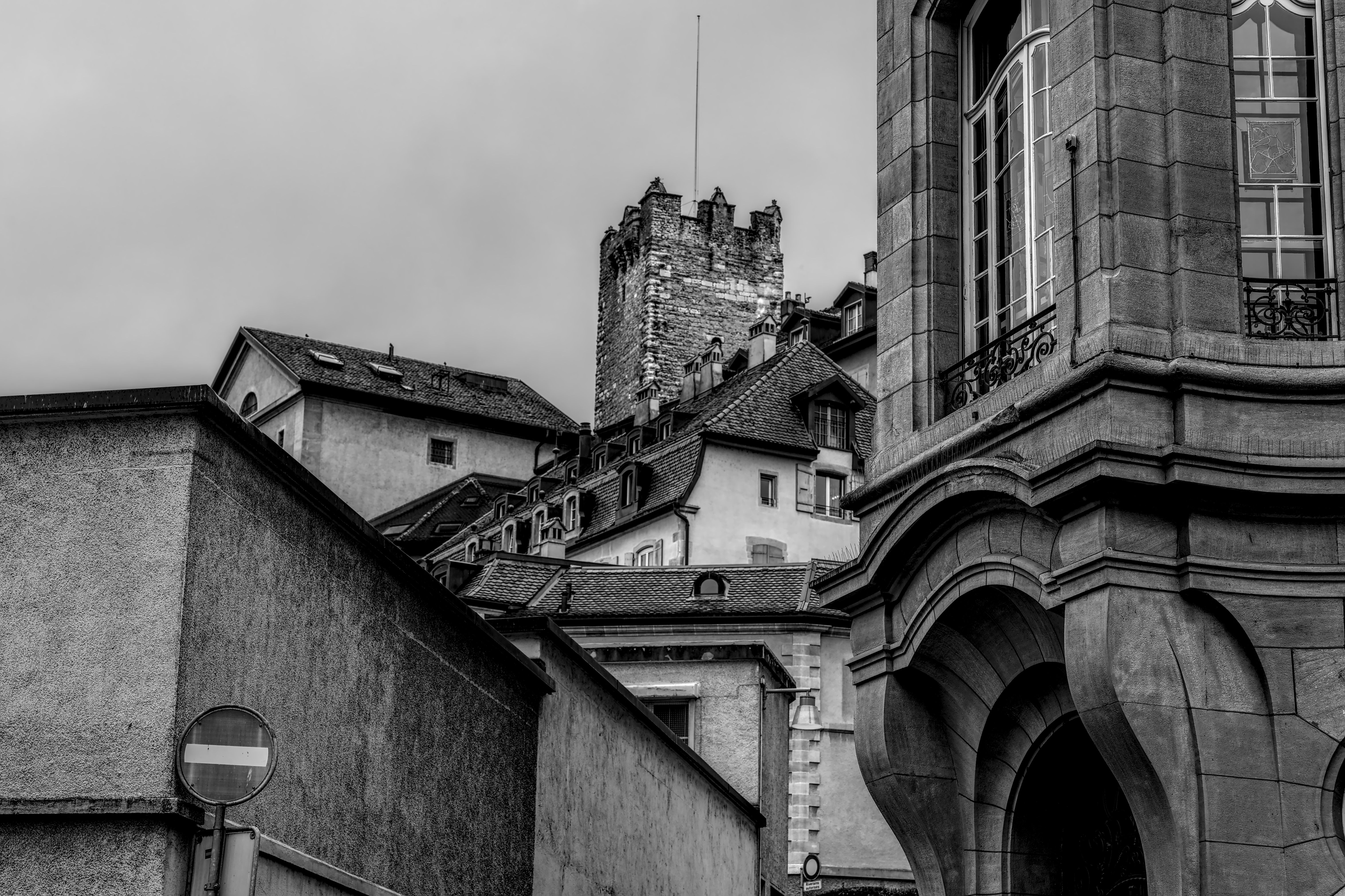 A striking black and white photograph of historic architecture in Neuchâtel, Switzerland.