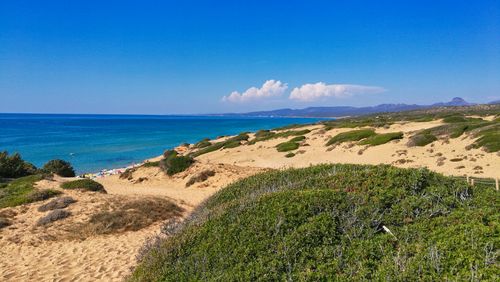 Free Breathtaking view of the golden dunes and azure sea at Piscinas, Sardinia, Italy. Stock Photo